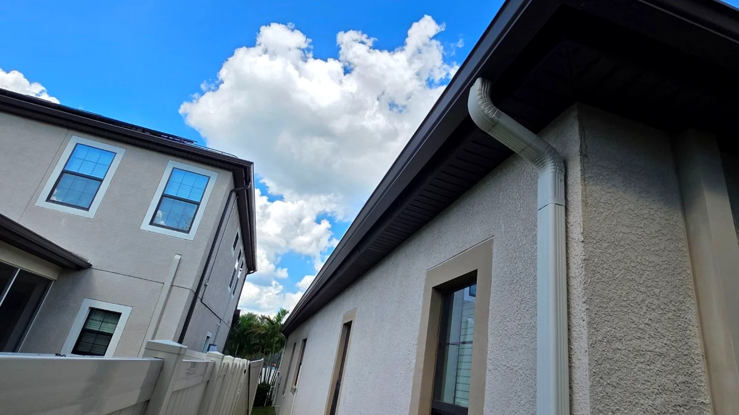 White gutter system along a Florida side yard